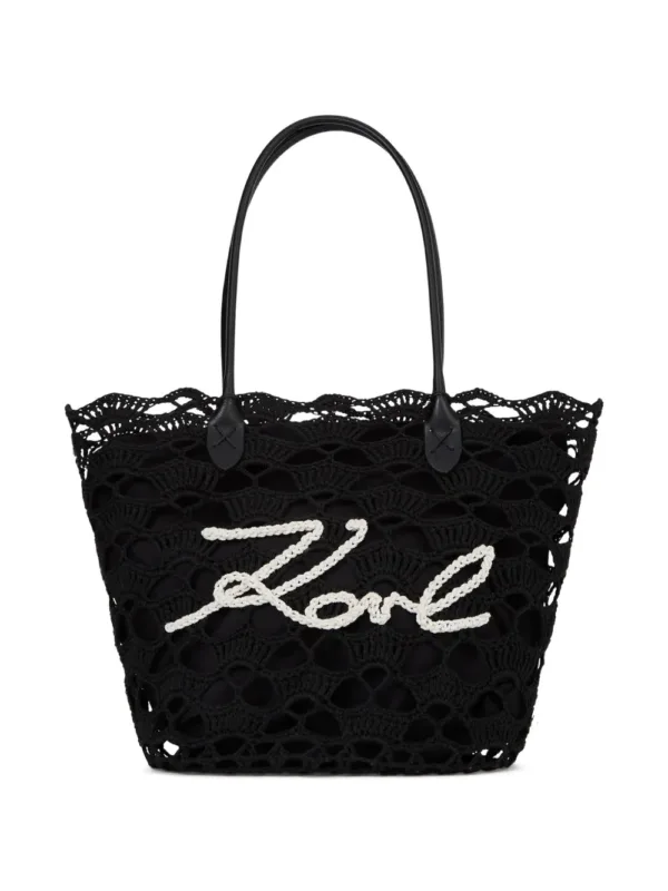 intricate openwork crochet tote bag with logo detail